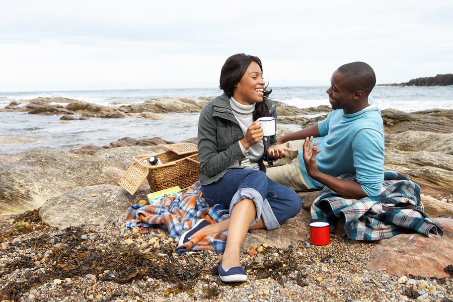 Couple having picnic on beach